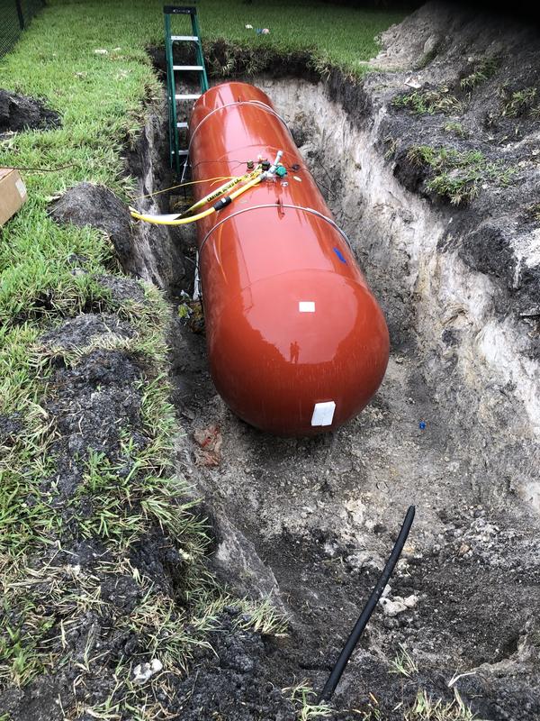 Propane tank set in a trench before backfill